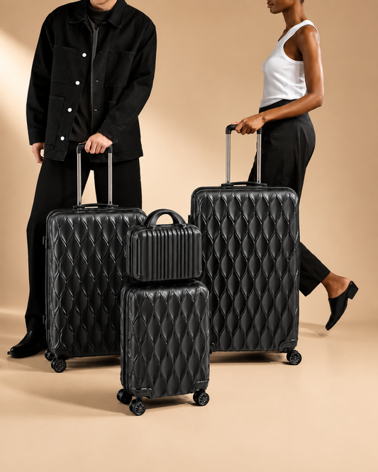 Anstruther black carry-on suitcase set in studio lifestyle shoot with matching travel bag and smooth rolling wheels