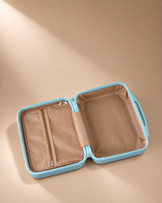 Open blue mini suitcase cosmetic bag showing tan organiser interior and mesh zipper pocket on beige studio background
