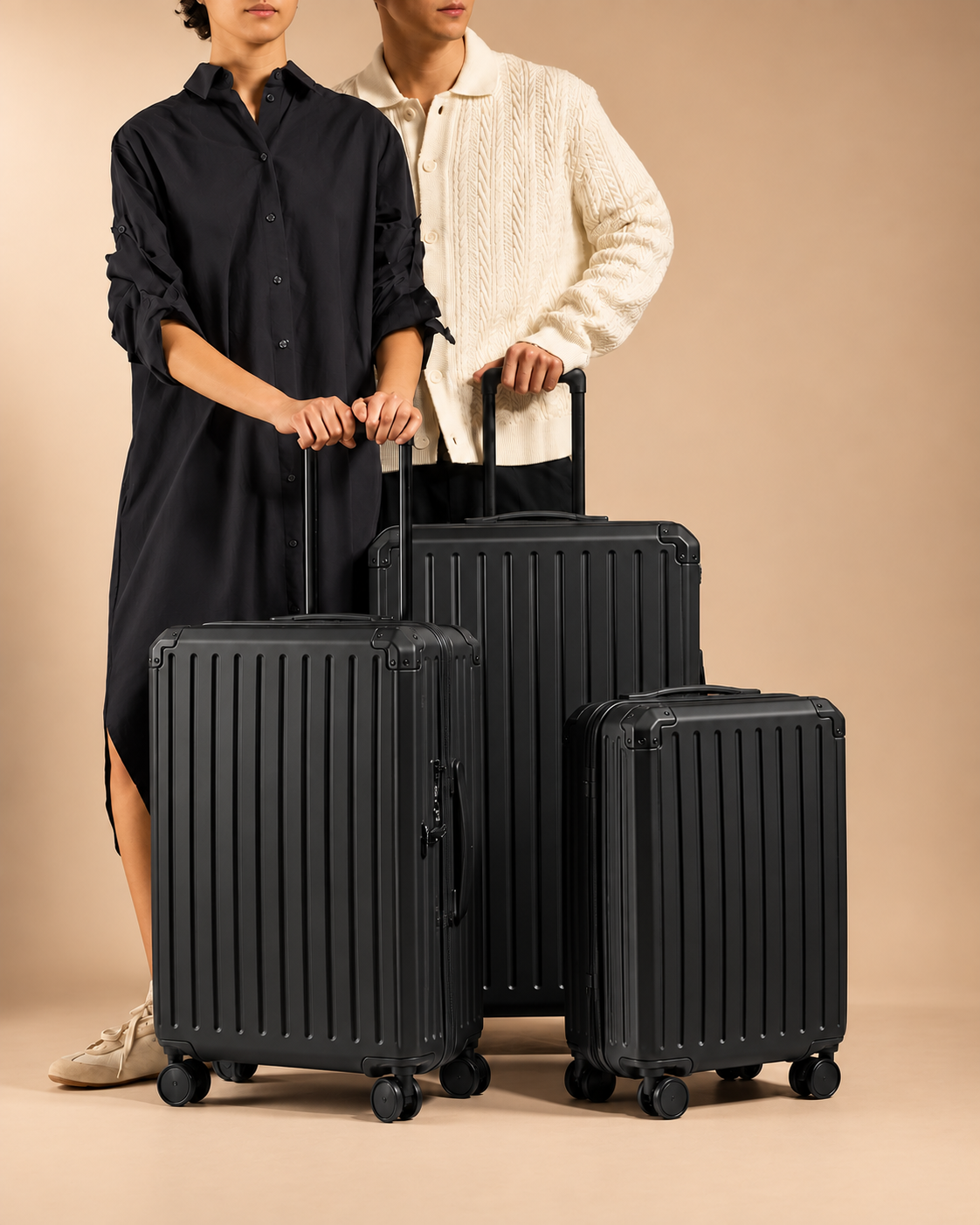 Tresaith black 4 piece suitcase set in lifestyle studio shoot with premium ribbed hard shell luggage