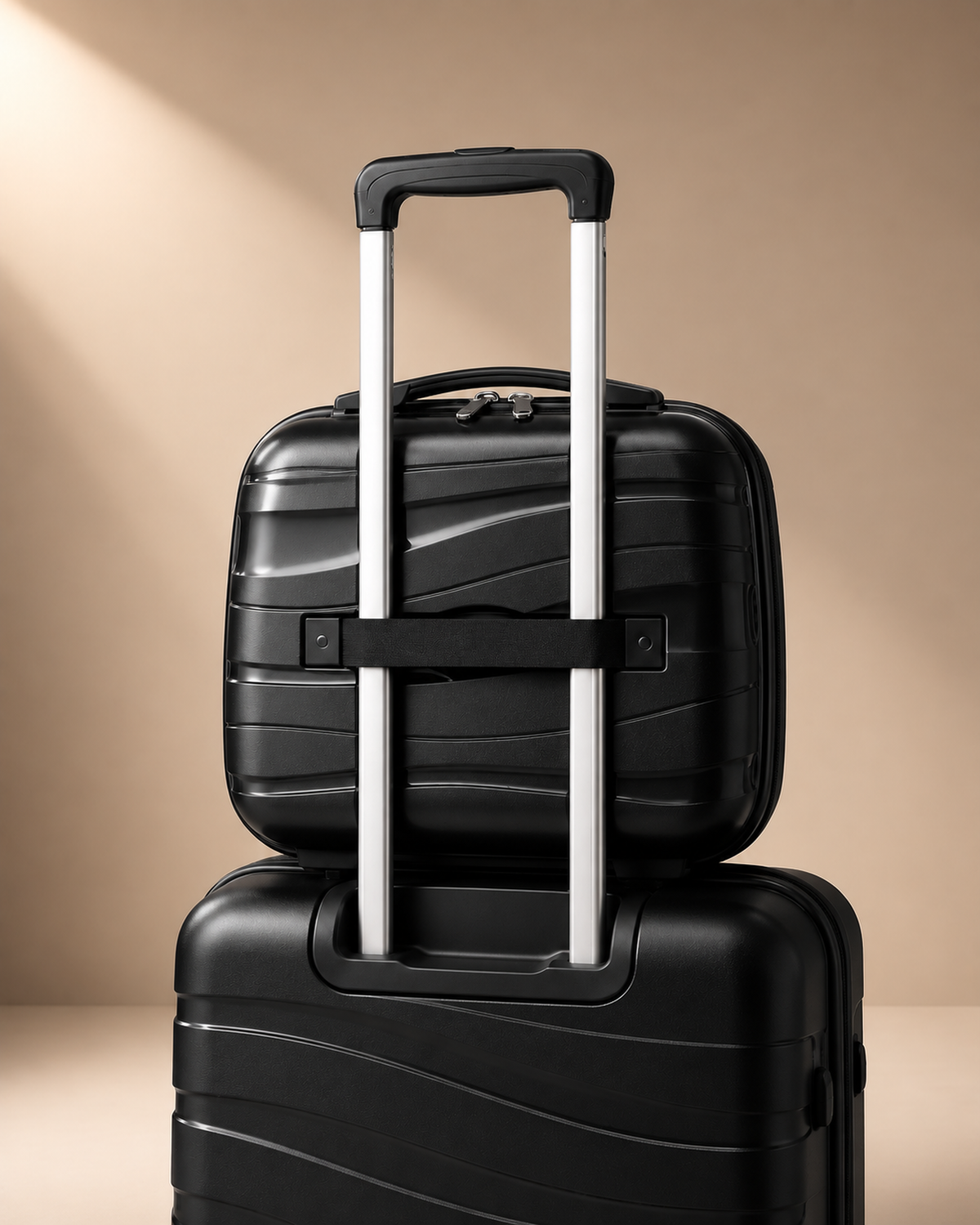 Housel black hard shell travel makeup case shown with trolley handle detail and matching luggage styling.