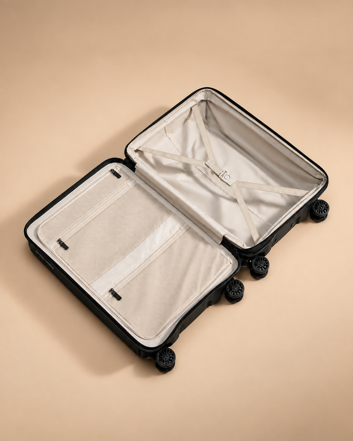 Anstruther suitcase open interior with cream lining, mesh pockets and cross straps for organised packing
