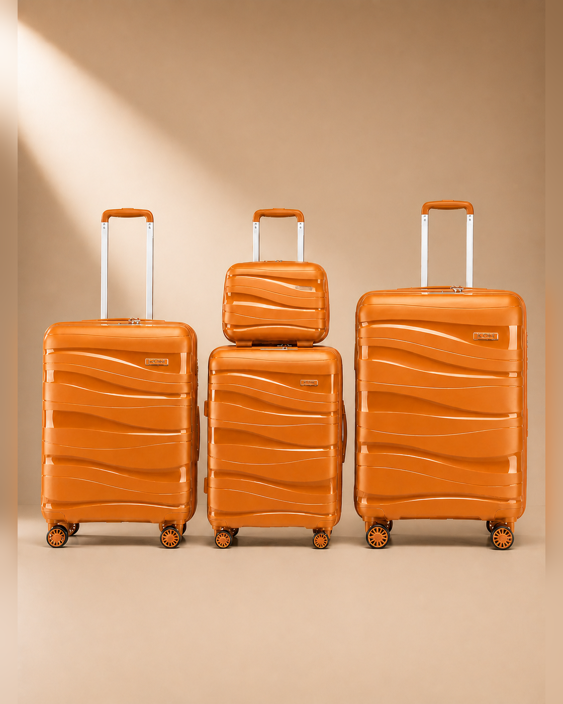 Rhosneigr 4 Piece Hard Shell Suitcase Set - Orange colour variant. Clean premium studio product photography with smooth background and polished hard shell suitcase finish.