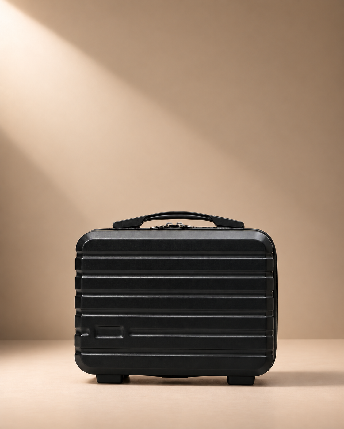 Black mini suitcase cosmetic bag with hard shell, zip closure and top handle on beige studio background