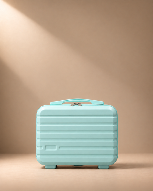 Blue mini suitcase cosmetic bag with hard shell, zip closure and top handle on realistic beige studio background