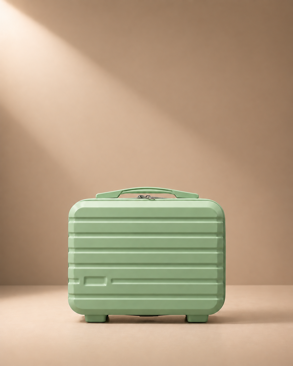 Green mini suitcase cosmetic bag with hard shell, zip closure and top handle on beige studio background
