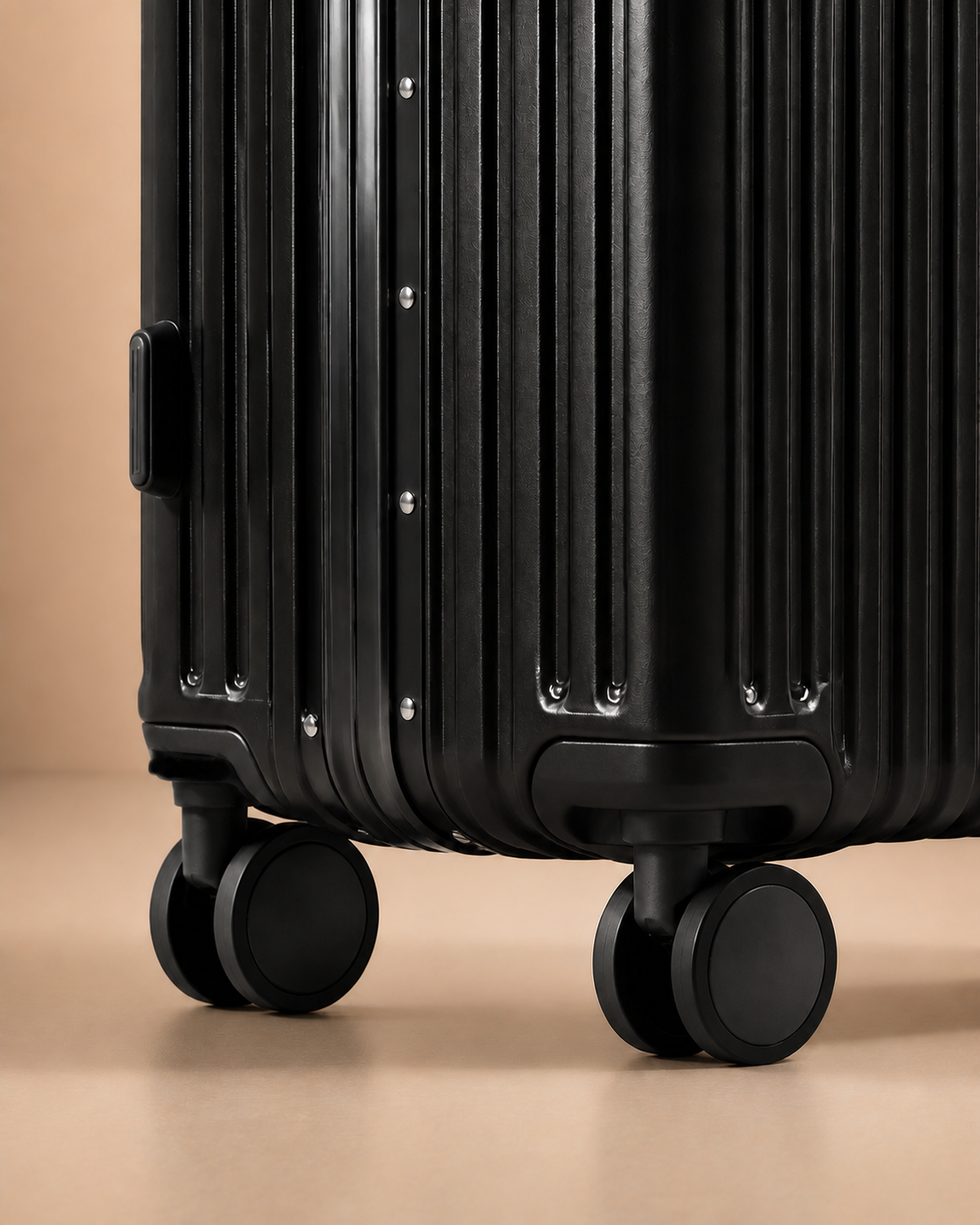 Black ribbed cabin suitcase spinner wheels close-up detail