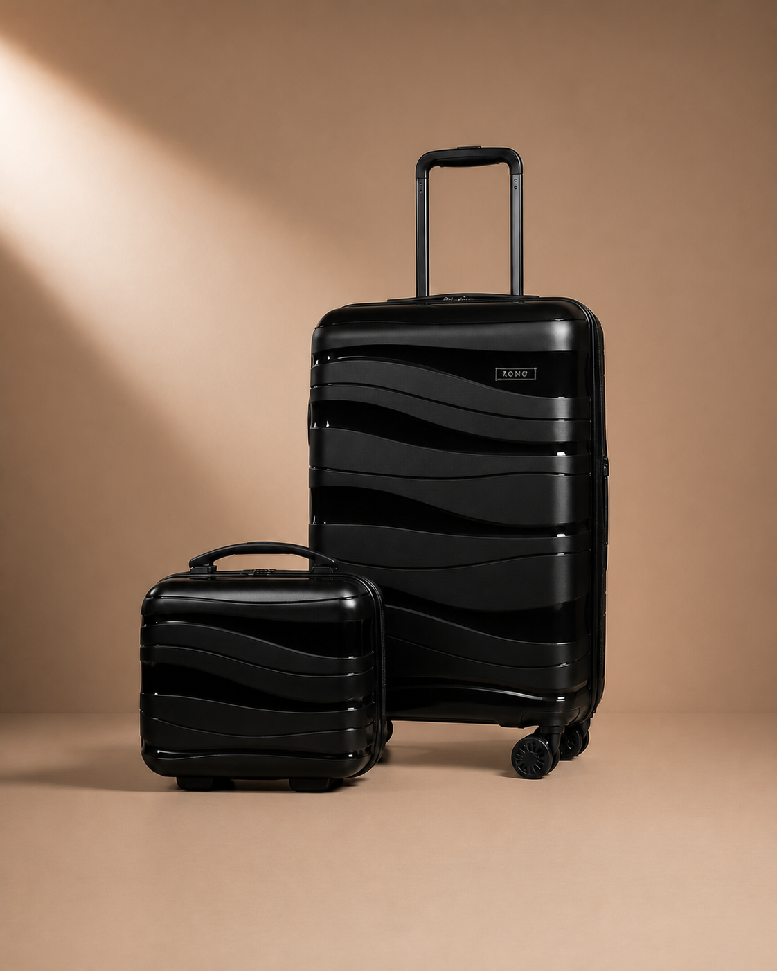 Black hard shell travel makeup case and suitcase set on a warm studio background