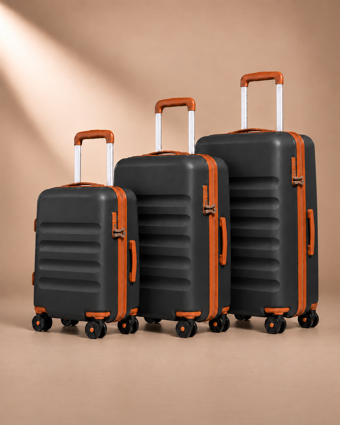 Painswick black hard-shell suitcases in three sizes, showing telescopic handles, spinner wheels and horizontal shell grooves.