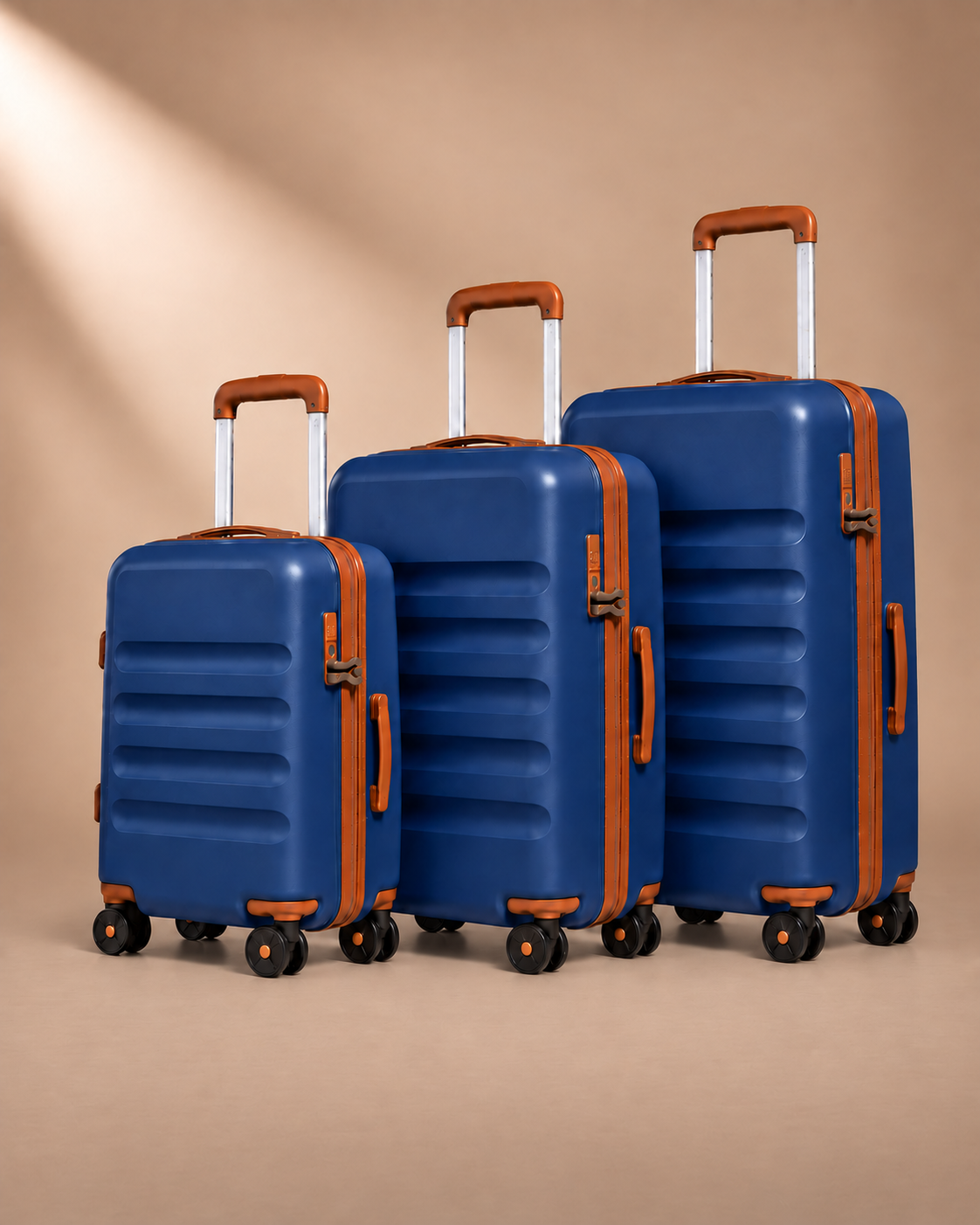 Painswick navy blue hard-shell suitcases in three sizes, showing telescopic handles, spinner wheels and horizontal shell grooves.