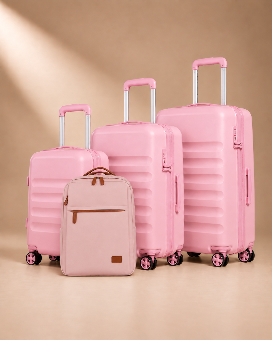 Painswick pink hard-shell suitcase set with three wheeled suitcases and a travel backpack with a front zipped pocket.