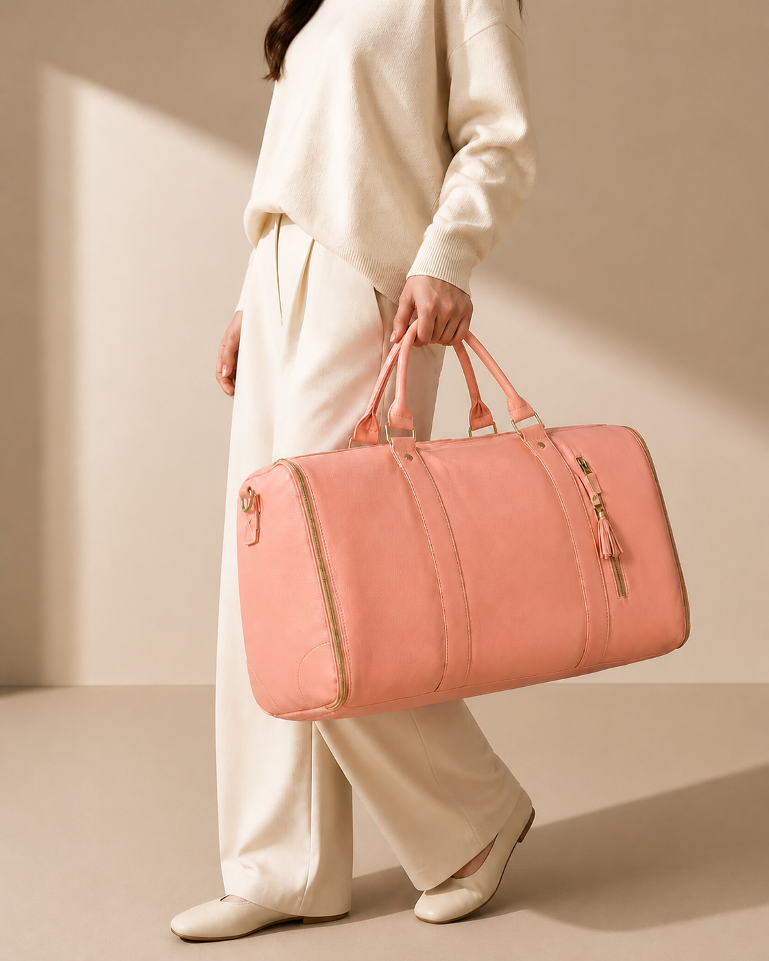 Pink garment travel bag carried by model in a premium studio travel scene