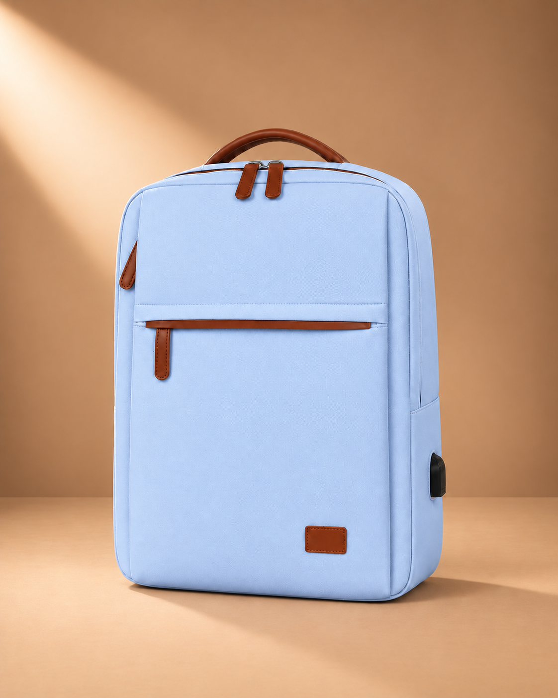 Light blue travel backpack with tan carry handle, front zipped pocket and side pocket, shown from the front at a slight angle.